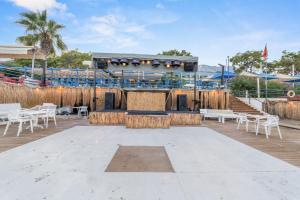 a large amphitheater with white chairs and a stage at Club Hotel Rama in Beldibi