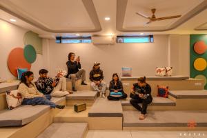 a group of people sitting on steps in a room at Zostel Jaipur, MI Road in Jaipur
