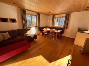 a living room with a couch and a table at Appartements Birkenhof in Lech am Arlberg