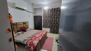 a small bedroom with a bed in a room at Vishwanathan in Varanasi