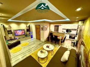 a living room with a couch and a table at Holiday Home Zelena Oaza in Sarajevo