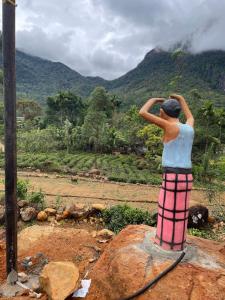 a man standing on a rock looking at a mountain at green view 5th mile in Norton Bridge
