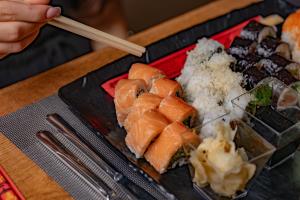 a tray of sushi and rice on a table with chopsticks at Club Hotel Rama in Beldibi