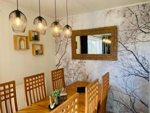 a dining room with a table and a mirror at Family Home in Sourbrodt in Sourbrodt