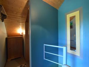 a hallway with blue walls and a wooden ceiling at Family Home in Sourbrodt in Sourbrodt +36 photos