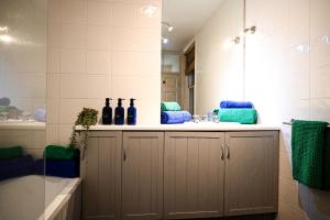 a bathroom with a sink and a mirror at Cathedral Cottage in Canterbury +49 photos