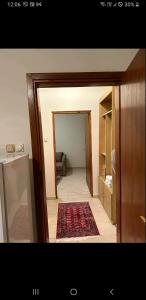 a view of a hallway with a rug in a room at Lily in Sremska Kamenica