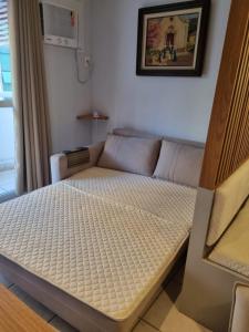 a bed in a living room with a couch at Best Residence in Rio de Janeiro +8 photos