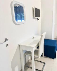 a white desk in a room with a window at Aurea Suites in Palermo
