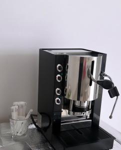 a coffee maker sitting on top of a counter at Aurea Suites in Palermo