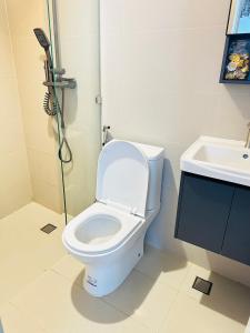 a bathroom with a toilet and a sink at Saffron Villa in Pampang +12 photos