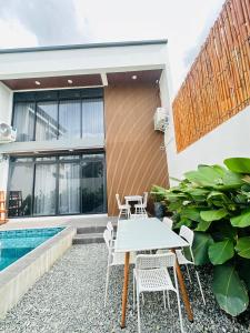 a patio with a table and chairs next to a house at Saffron Villa in Pampang