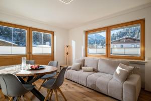 a living room with a couch and a table at Chalet Veronika in Fieberbrunn