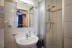 a bathroom with a sink and a shower at Chalet Veronika in Fieberbrunn +18 photos