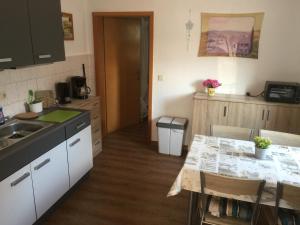 a kitchen with a sink and a table in it at Villa Arizona in Bad Schandau