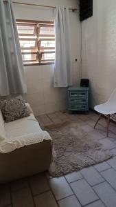 a bedroom with a bed and a window and a rug at Casa - BC in Balneário Camboriú