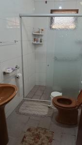 a bathroom with a shower with a toilet and a sink at Casa - BC in Balneário Camboriú +4 photos