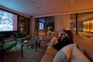 two women sitting on a couch in a living room at FAV LUX Nagasaki in Nagasaki +42 photos