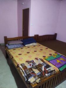 a bed with a colorful comforter in a bedroom at Ocean Sparrow Home Stay in Gokarna