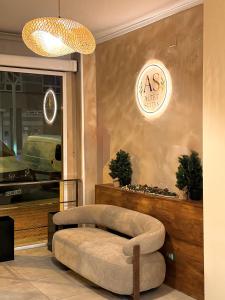 a room with a chair in front of a store at HS Altet Suites - Alicante Airport in El Alted