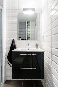 a bathroom with a sink and a mirror at Apartament Jaśminowy in Gdańsk