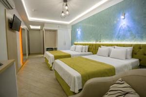 a hotel room with two beds and a tv at Hotel Pera Capitol - Taksim & İstiklal in Istanbul