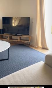 un soggiorno con una grande televisione e un tavolo di Faisões vila a Cascais