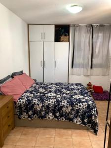 a bedroom with a bed with a black and white blanket at Apto jaraguá lindo in Maceió