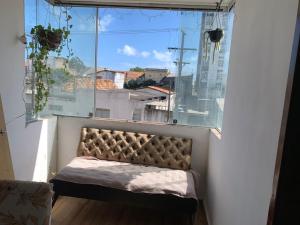 a bench in a window with a view of a city at Apto jaraguá lindo in Maceió