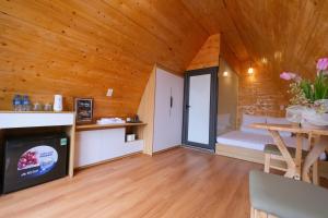 a room with a bed and a table in a room at Cỏ Mây Wonder Homestay in Mộc Châu