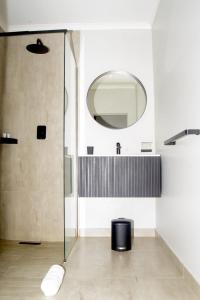 a bathroom with a shower and a mirror at Margate Hotel in Margate