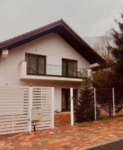 a white house with a balcony and a fence at Imperial Home Chalet in Sibiu