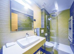 a bathroom with a sink and a toilet at Hotel Risnjak in Delnice +30 photos