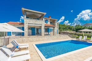 a villa with a swimming pool and a house at Villa Sterpazzi near Poreč with heated private pool, sea view, jacuzzi and sauna in Višnjan