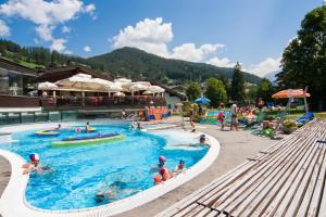 a group of people in a pool at a resort at Residence Palmai in Ortisei