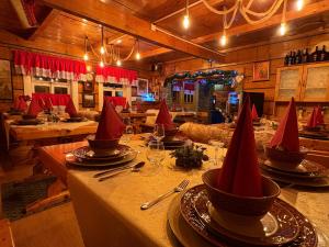 een eetkamer met een tafel met rode hoeden erop bij Zrub Niki in Ždiar