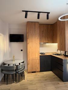 a kitchen with a table and some chairs and a table and a kitchen at 10 minutes from skiing in Bakuriani