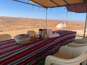 ESCAPE cAMp في Badīyah: طاولة عليها طعام مع إطلالة على الصحراء
