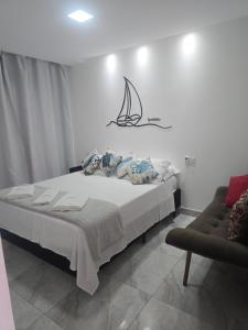 a bedroom with a bed with a sail on the wall at Oceano Residence in Búzios
