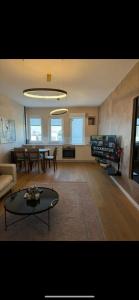 a living room with a couch and a table at The Gallery Apartment in Prishtinë