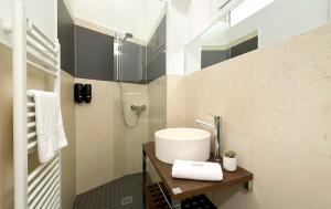 a bathroom with a white sink and a shower at Dusdei 4 - monolocale nel centro di Sondrio in Sondrio