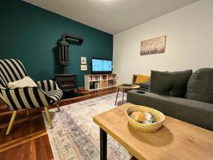 a living room with a couch and a stove at Chalet Pahulja in Jahorina
