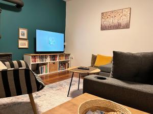 a living room with a couch and a tv at Chalet Pahulja in Jahorina