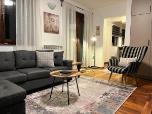 a living room with a couch and two chairs at Chalet Pahulja in Jahorina