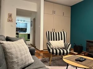 a living room with a couch and a chair at Chalet Pahulja in Jahorina +36 photos