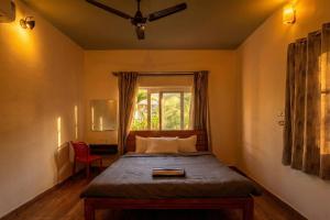 a bedroom with a bed and a window at Hong Sau Resort - Luxury Nature Escape, Sakleshpur in Sakleshpur +86 photos