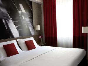 Postel nebo postele na pokoji v ubytování Aparthotel Adagio Vienna City + 48 fotografií