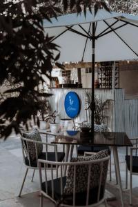 a table and chairs with an umbrella on a patio at Ramat Niwas By Kutani Stays in Jaipur