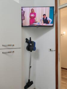 een flatscreen-tv hangend aan een muur met een camera bij Casa ALFRED FIDENZA in Fidenza