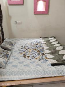 un letto con un piumone sopra di esso di Bapa Sitaram Homestay a Garudeshwar